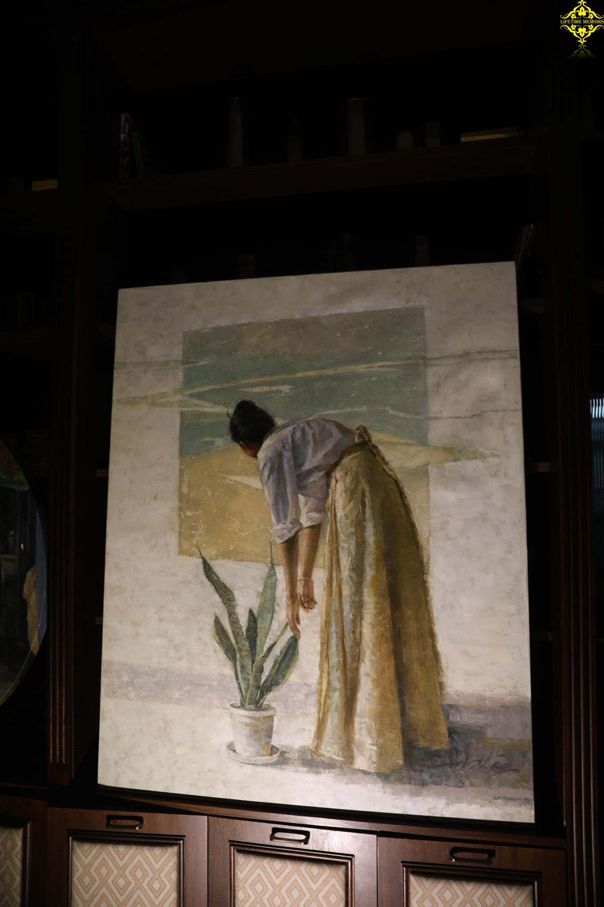 A woman bends toward a plant