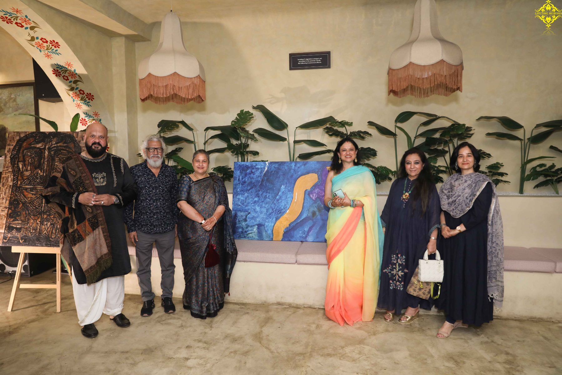 Guests beside the blue and gold abstract