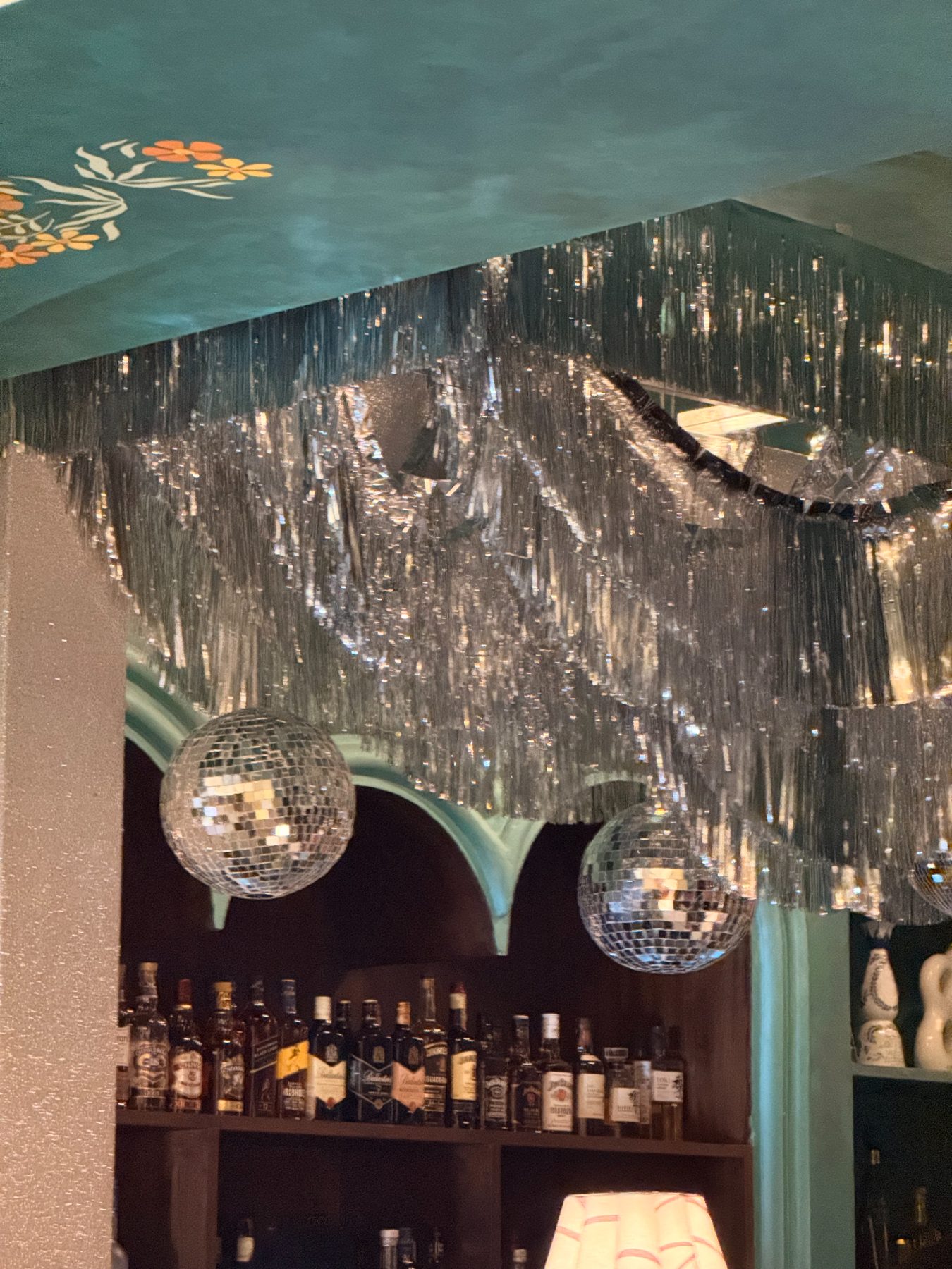 Silver tinsel and mirror balls over the bar