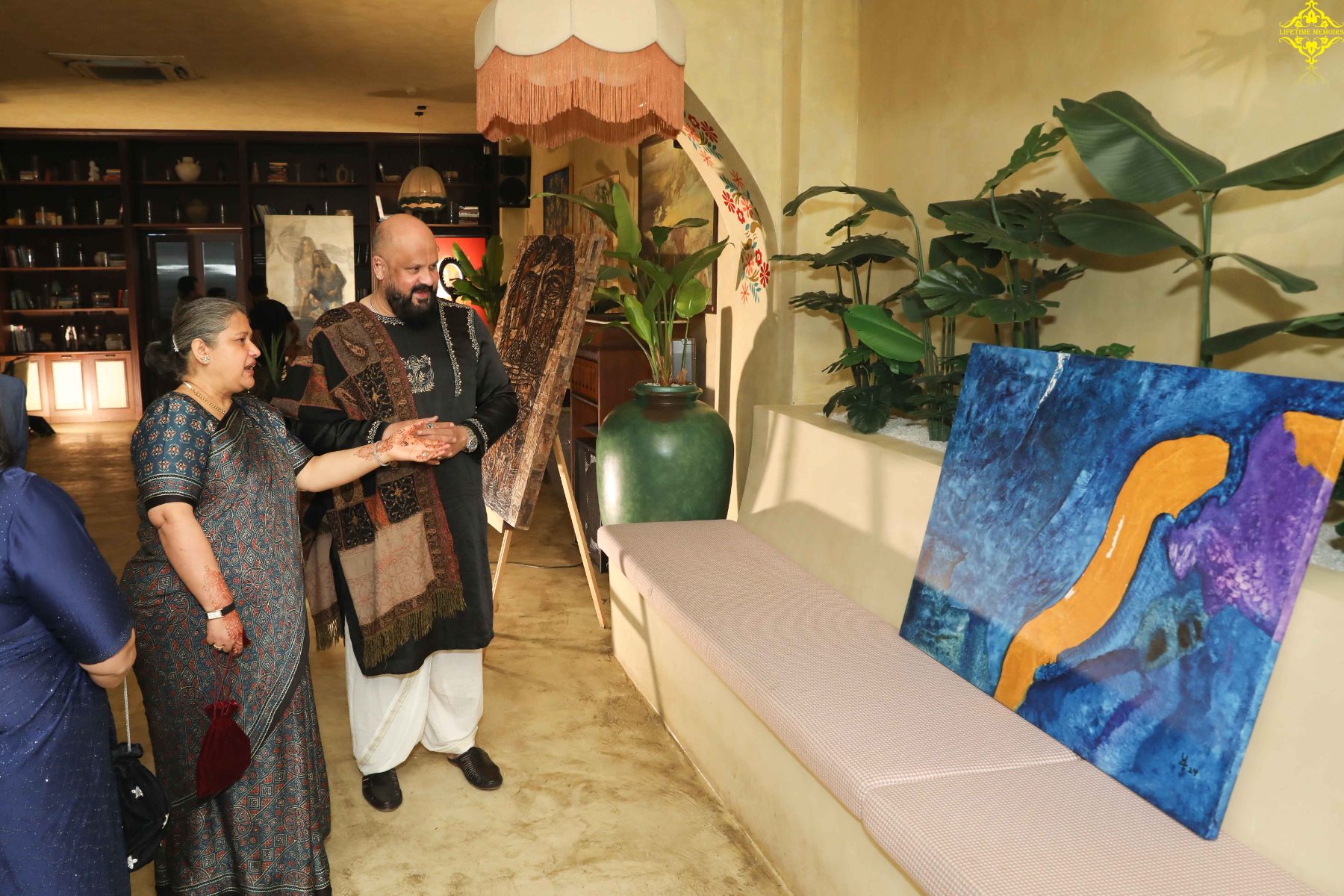 Guests discussing a blue abstract