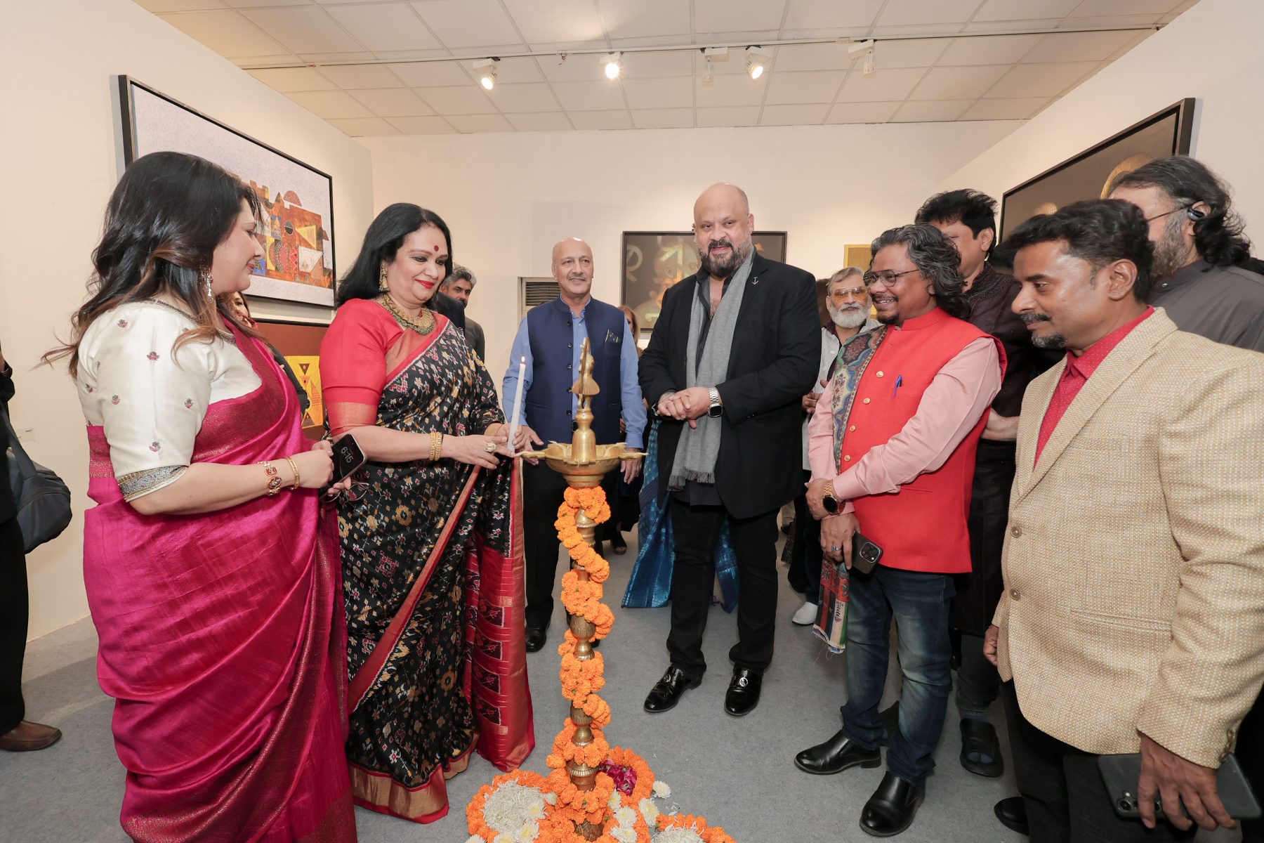 Guests lighting the brass lamp wound with marigolds